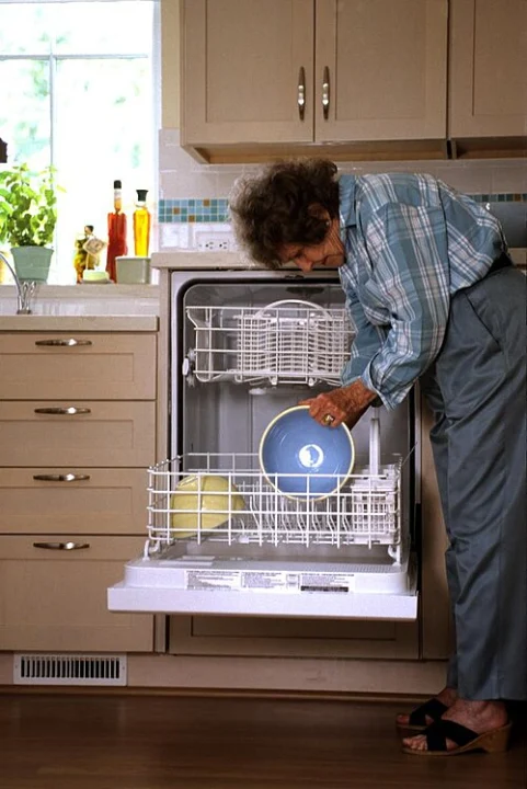 An open dishwasher installed in a kitchen